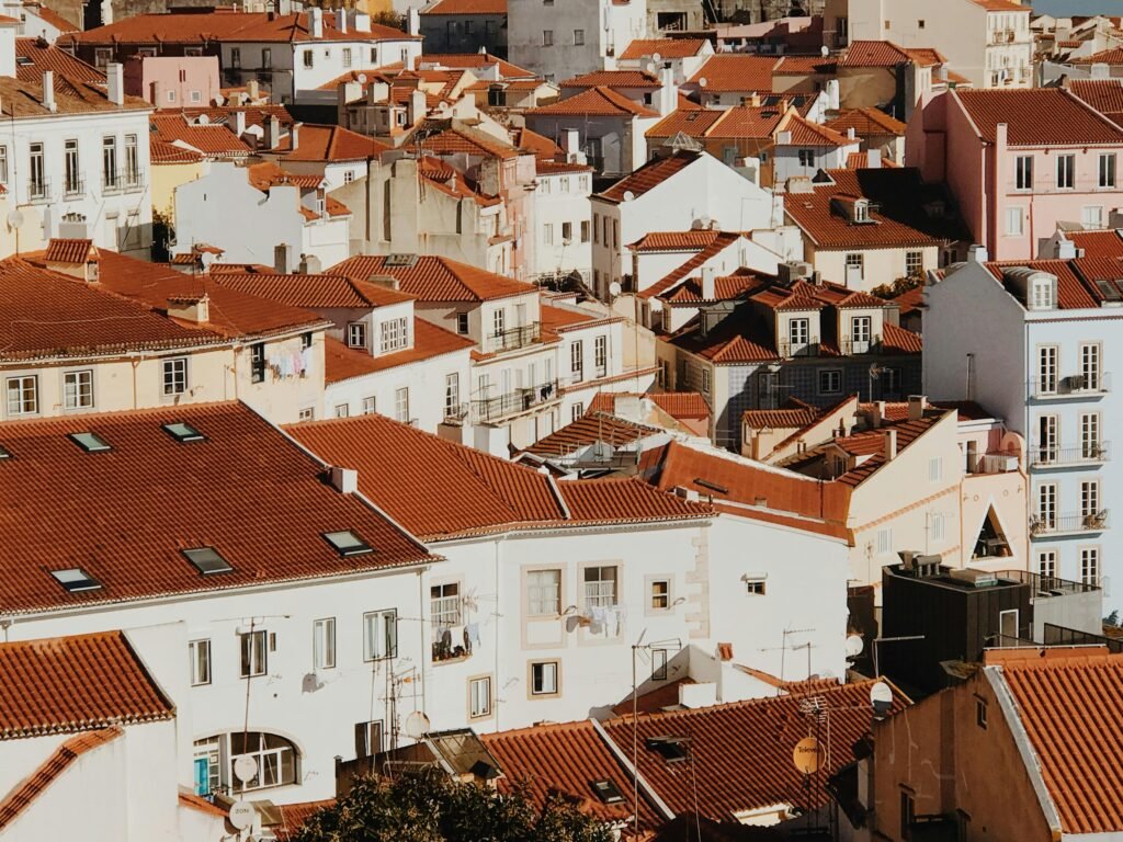 Discover Lisbon's charming rooftops and colorful buildings under the warm daylight, showcasing unique Iberian architecture.